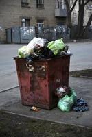 Garbage containers and bags with garbage on the street photo