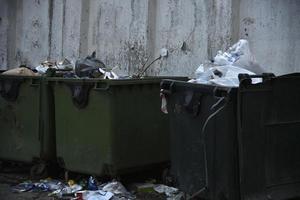 Garbage containers and bags with garbage on the street photo