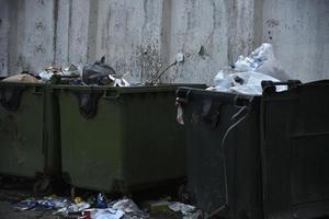 Garbage containers and bags with garbage on the street photo