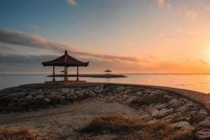 Bali pavilion on jetty at coastline in morning