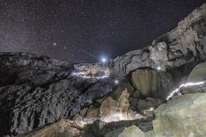 Rocky crater volcano with starry in the sky photo