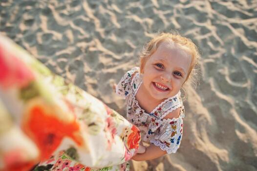 Daughter having fun on the beach. Portrait of happy cute little baby girl on vacation. photo