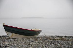 Wooden boats on the coast near the ocean photo