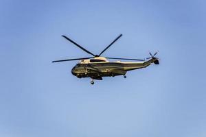 Green helicopter flying in the sky photo