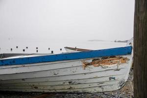 Wooden boats on the coast near the ocean photo