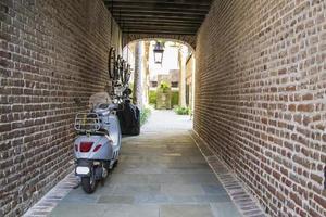 Blue scooter in brick alley photo