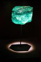 Green emerald stone in a museum being illuminated photo