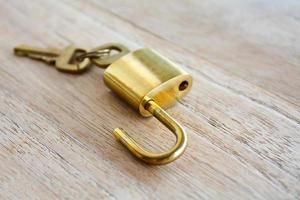 Golden padlock on wood background photo