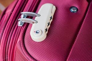 combination lock on red suitcase travel bag photo