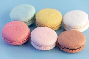 Sweet french macaroons cake pastel colored or macarons with vintage pastel blue colored background photo