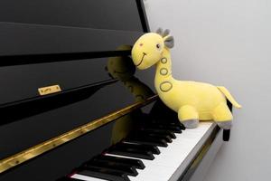 muñeca jirafa amarilla en el piano foto