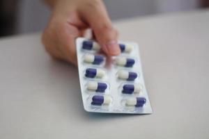 Close up of female doctor hands holding pills photo