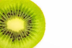 Slice of fresh kiwi fruit isolated on white background photo