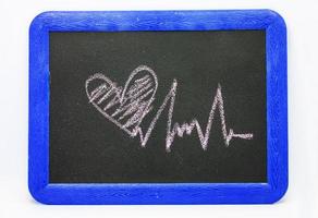 Heartbeat sign, love heart on a chalkboard photo