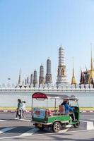 Bangkok Thailand April 13 2022 Tuk Tuk in front of Wat Phra Kaew, The Temple of the Emerald Buddha and The Grand Palace. Bangkok luxurious royal palace.