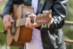 detail of hands playing guitar photo