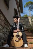 photo of boy holding guitar