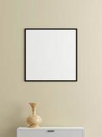 Minimalist square black poster or photo frame mockup on the wall in the living room with desk. 3d rendering.