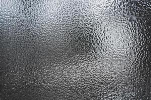 Abstract pattern of melt water on the window glass. photo