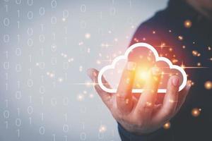 Businessman holding virtual clouds computing to transfer data information and upload or download database corporate with copy space. Technology transformation databases concept. photo