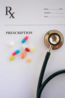 Pills and stethoscope on a prescription photo