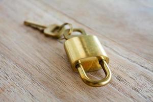 Golden padlock on wood background photo