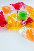 assorted hard candy in wrappers in pile with copy space photo