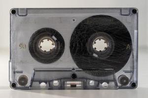 standing clear old retro cassette tape with tape wound on right A side photo