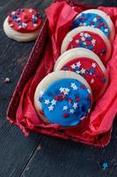 Festive Fourth of July cookies with star sprinkles on wooden table photo