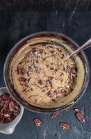 baking ingredients with Pumpkin, spices, and pecans in mixing bowl top view photo