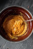 baking ingredients with Pumpkin and spices in mixing bowl top view photo