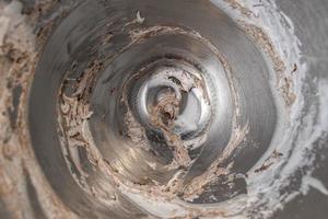 Remnants of Meringue and chocolate in mixing bowl top view photo