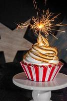red white and blue cupcake with toasted meringue swirl top and sparkler photo
