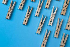 clothespins on vibrant blue pattern with copy space photo