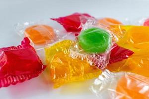 assorted hard candy in wrappers in pile with copy space