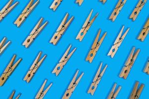 clothespins laid out in pattern on vibrant blue background photo