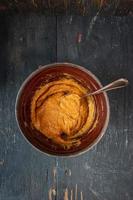 baking ingredients with Pumpkin and spices in mixing bowl top view photo