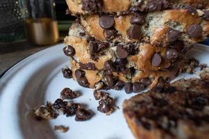 moody slices of chocolate chip banana bread loaf stacked on plate photo