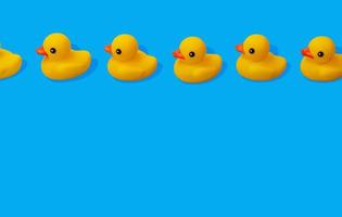 yellow rubber ducks in a row spaced out on blue background with copy space photo