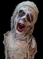 studio shot portrait of young boy in costume dressed as a Halloween, cosplay of scary mummy pose on isolated black background photo