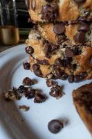 moody slices of chocolate chip banana bread loaf stacked on plate photo