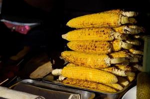 Grilled corn. Street food festival. Close up of appetizing grilled sweet corn on the bbq photo