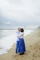 A loving couple, man and woman enjoying summer vacation on a tropical paradise beach with clear sea ocean water and scenic photo