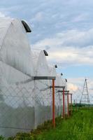 Greenhouses in Ukraine against the sky with clouds. photo