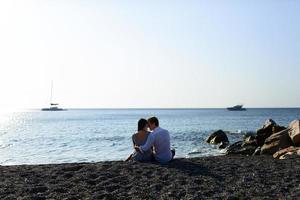 Young beautiful couple kissing on sea background. photo