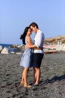 Young beautiful couple kissing on sea background. photo