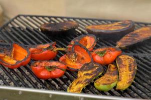 Grilled red and yellow peppers during a street food festival. photo