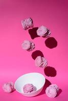 marshmallow in pink colors on pink background with copy space photo