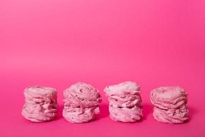 marshmallow in pink colors on pink background with copy space photo