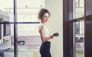 Sporty young woman with dumbbells photo